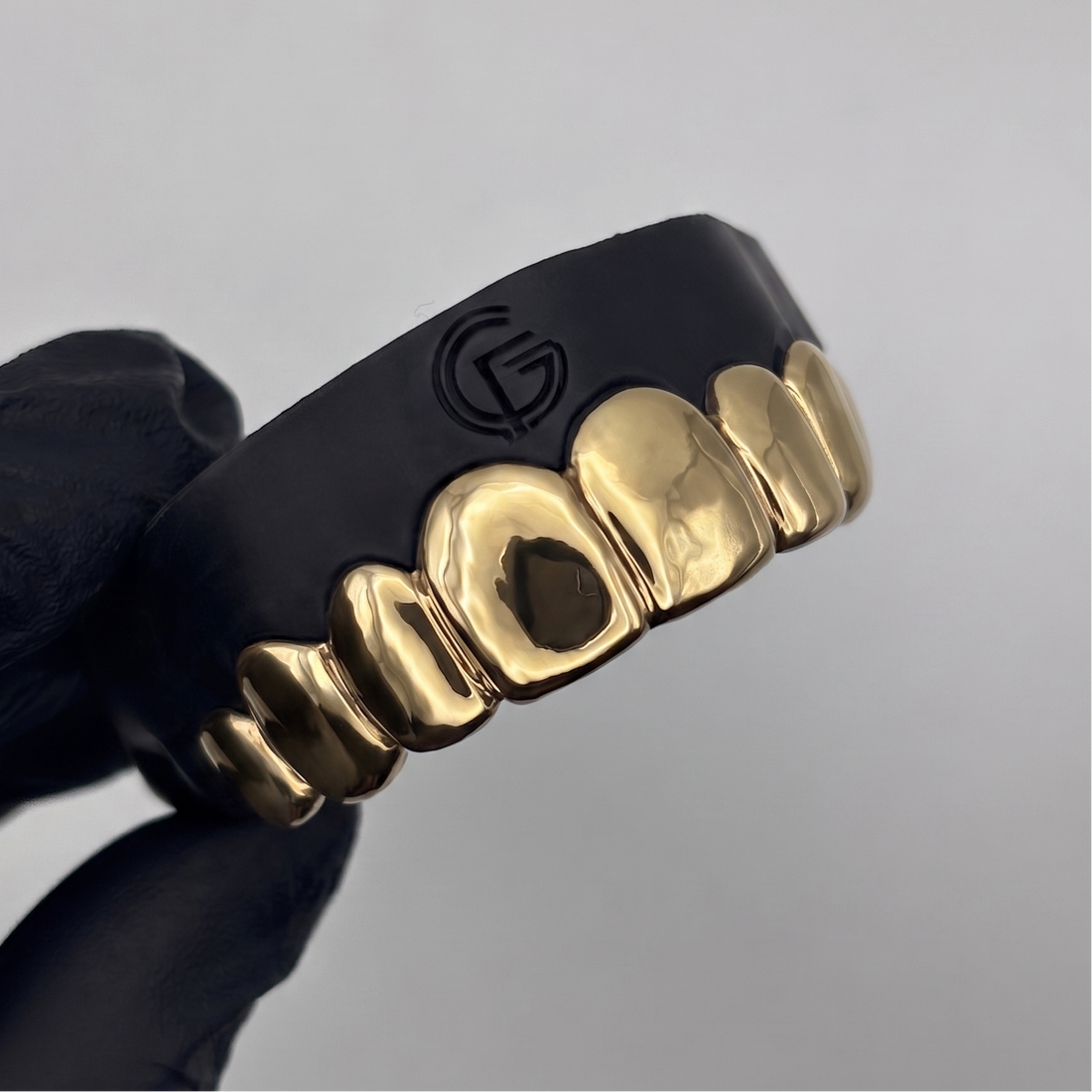 Custom 8 piece solid gold grillz set handcrafted in New Zealand